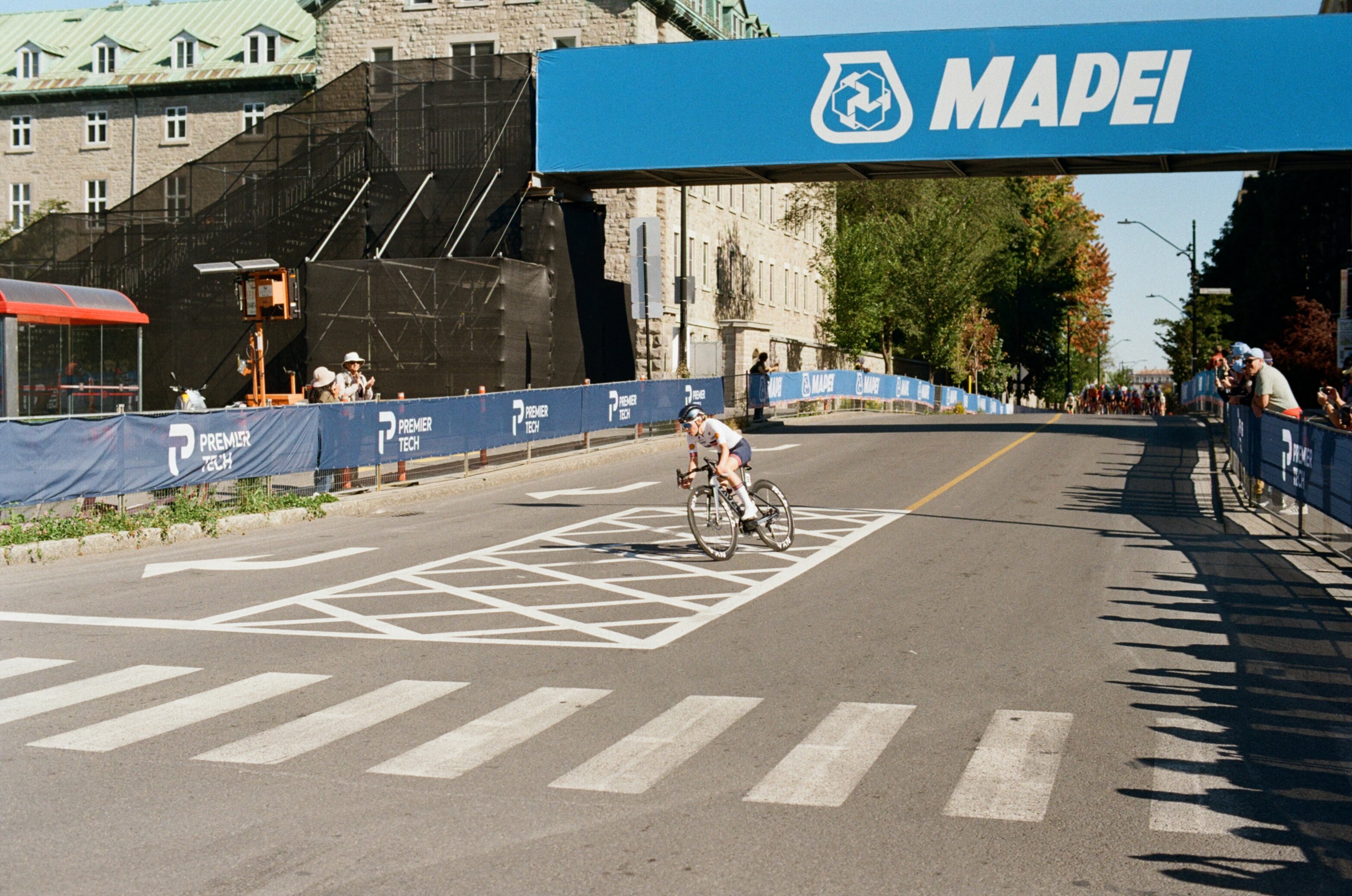A cyclist rounds a corner in a women's bike race