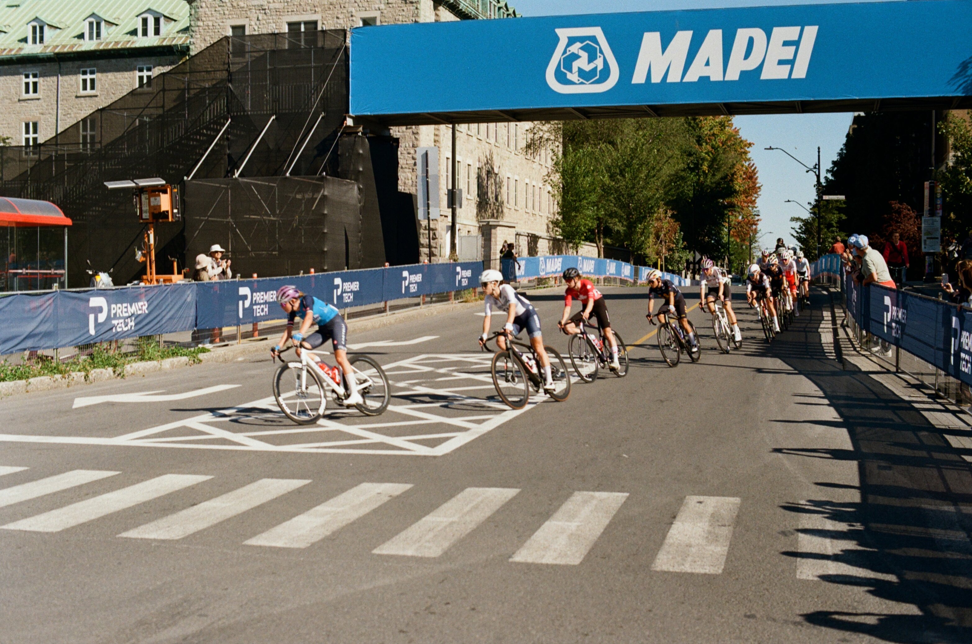 Cyclists round a corner in a women's bike race