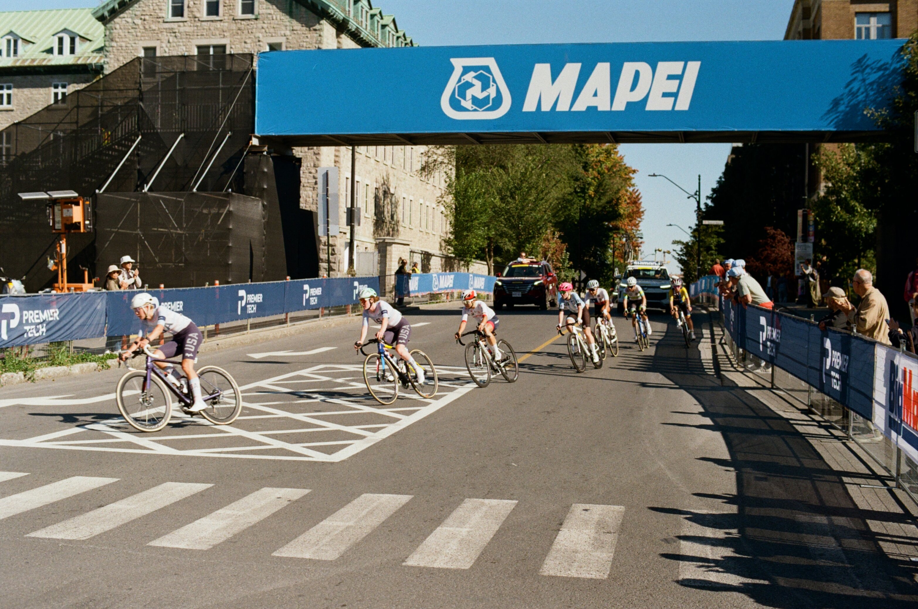 Cyclists round a corner in a women's bike race