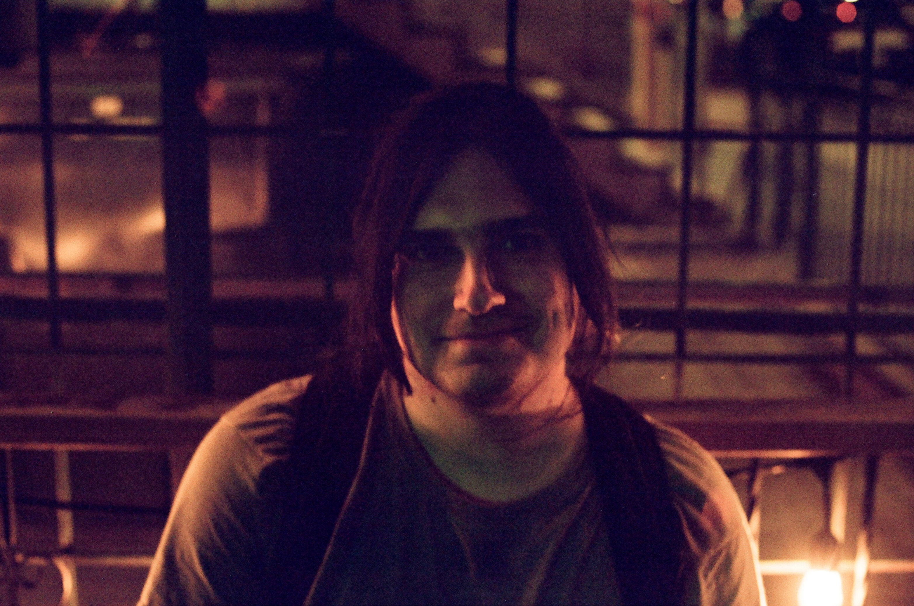 A man sitting on a bench at night