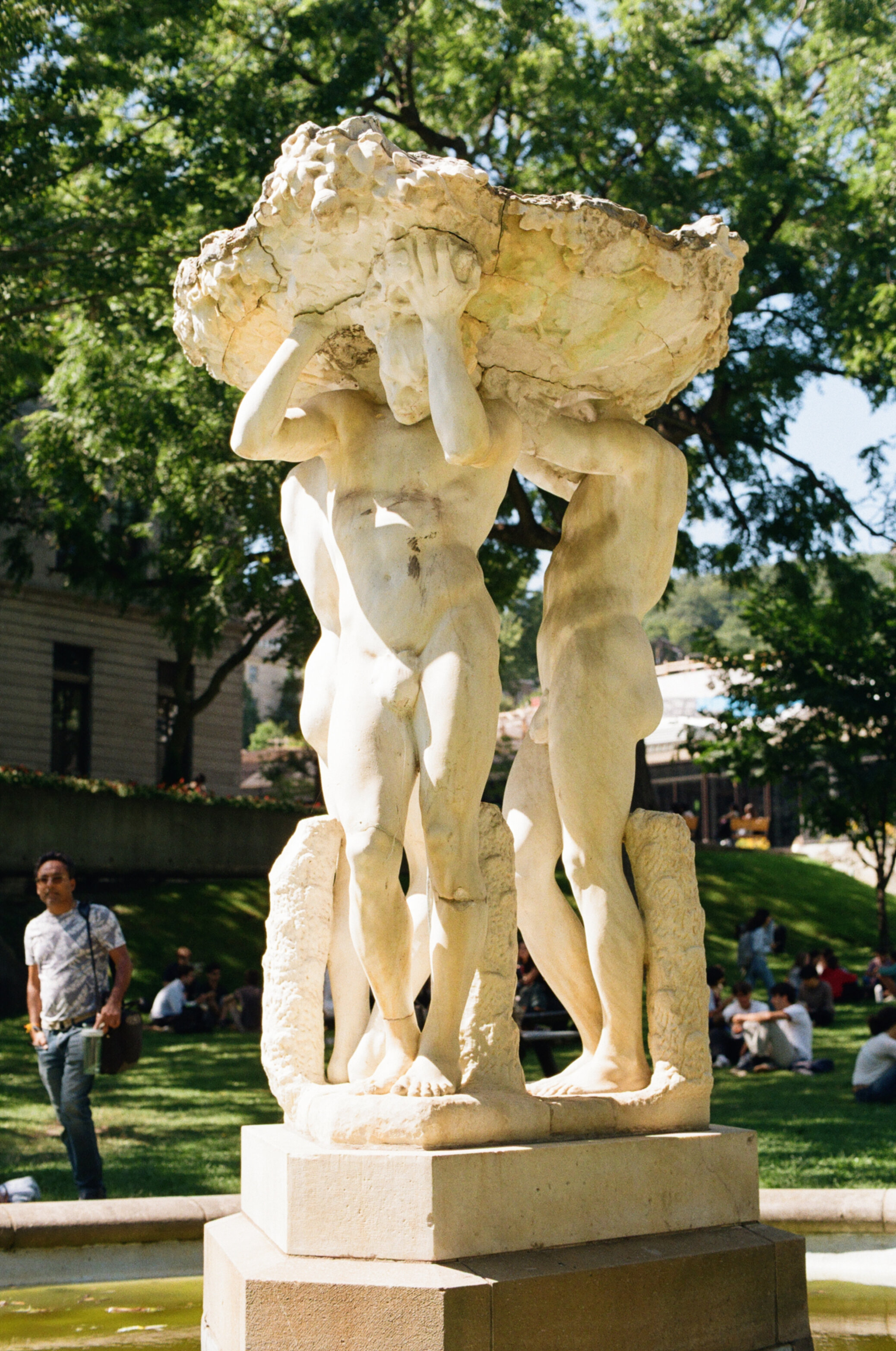 Marble fountain in the shape of a platform held up by three nude men